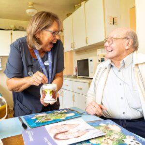 carer-laughing-in-kitchen-with-older-gentleman Carer laughing in kitchen with older gentleman