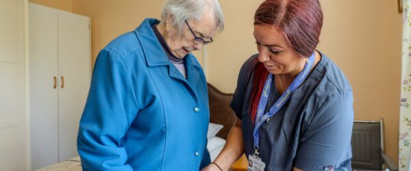 Carer helping older lady with dementia care