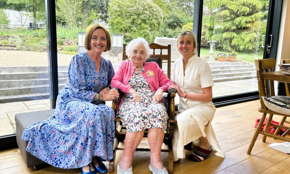 Elderly lady celebrating 100th birthday with family